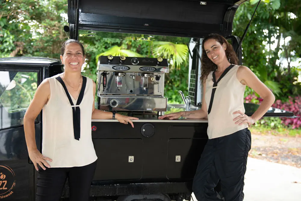 2 Barista standing in front of the "buzz" coffee cart, ready to serve.