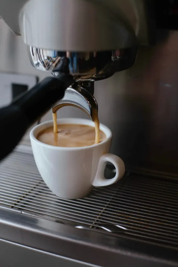 espresso pouring out of a coffee machine